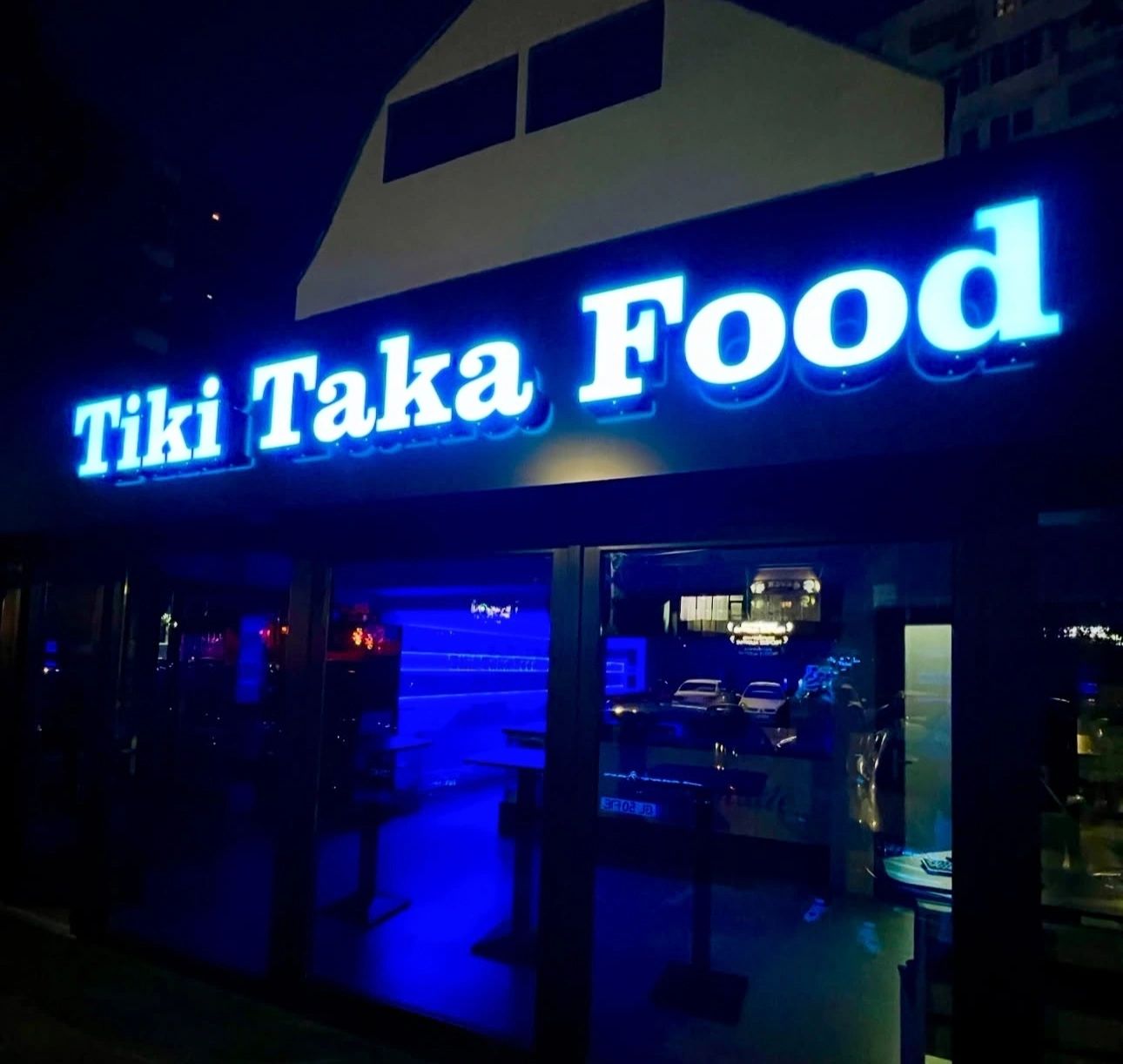 Tiki Taka Food storefront at night